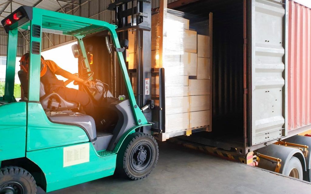 forklift-driver-loading-cargo-pallet-shipment-into-a-truck-container-1